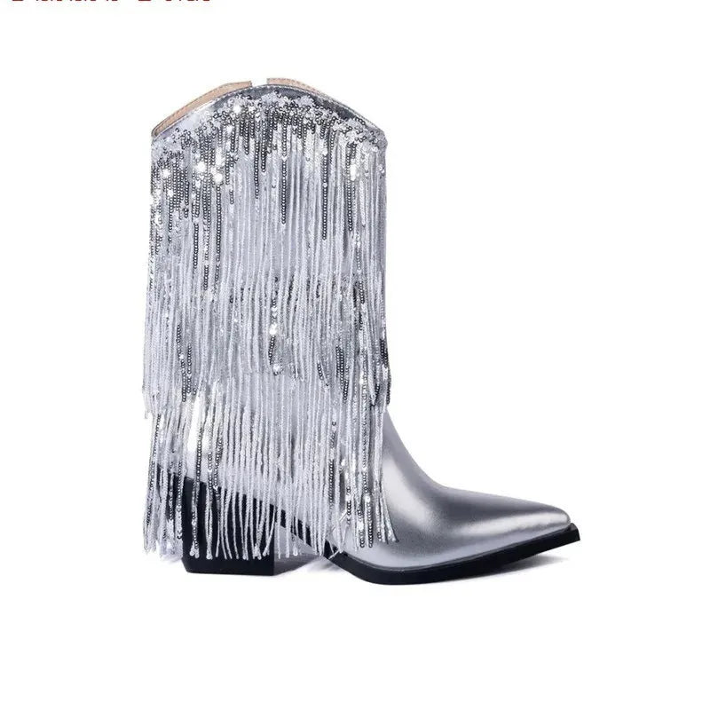 Women's black chunky heel tassel boots with pointed toe and high stiletto, shown on a model.