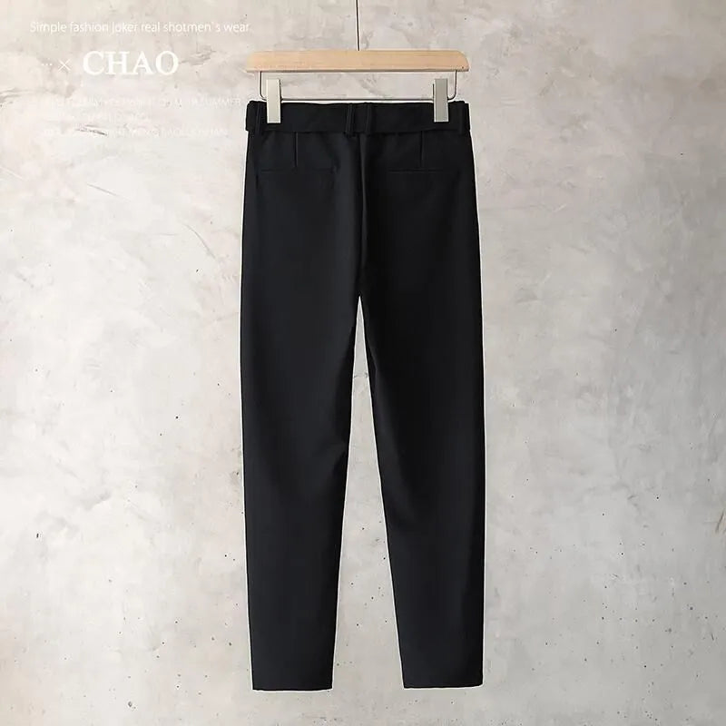 Boy wearing slim straight grey wool blend business casual trousers with a tapered fit