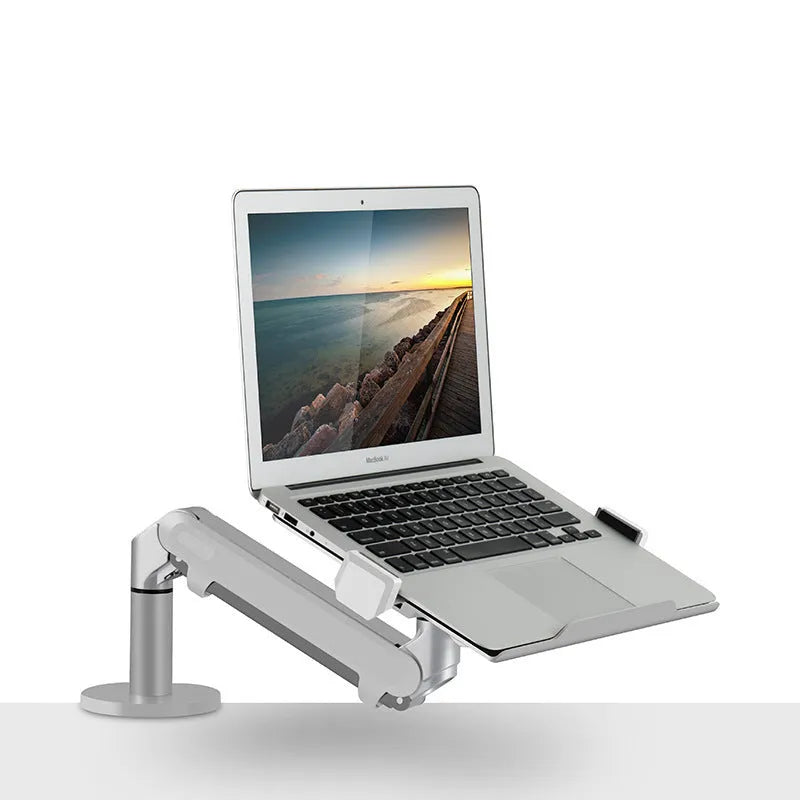Silver aluminium laptop stand with adjustable air pressure arm holding a notebook above desktop