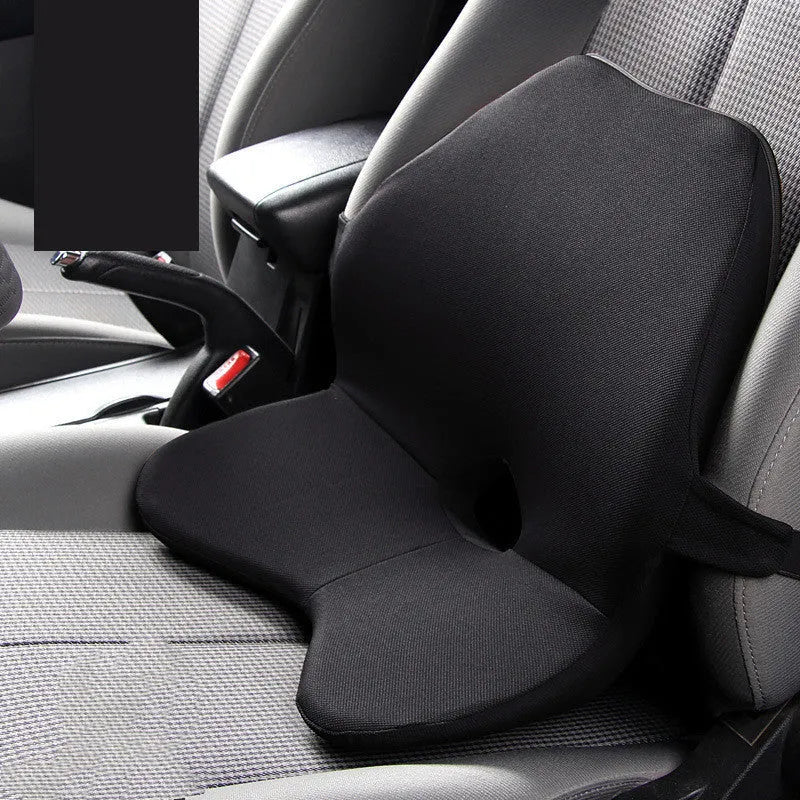 Black memory foam car lumbar support cushion with elastic straps, shown on a grey car seat.