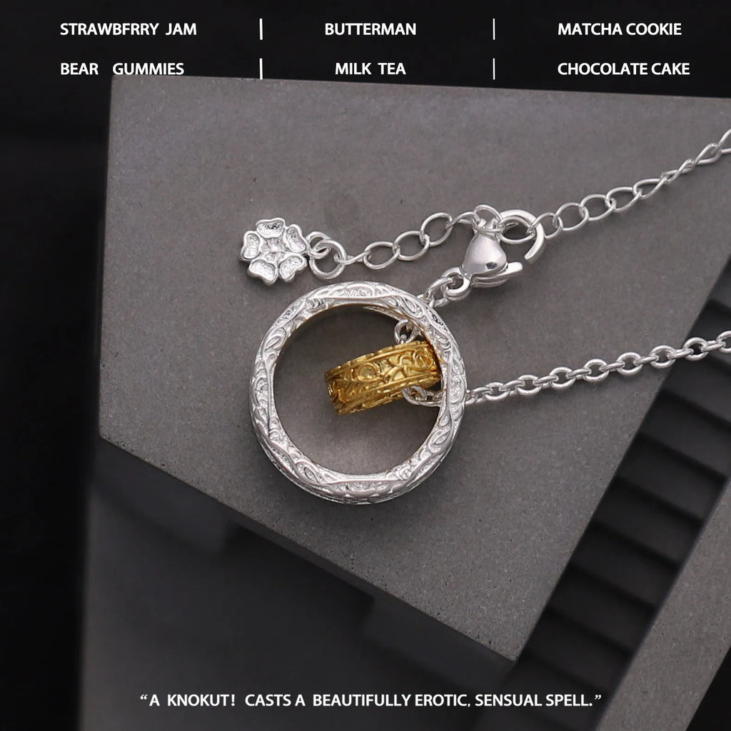 Geometric copper nested necklace with gold and silver electroplated finish, round and ring elements, on display