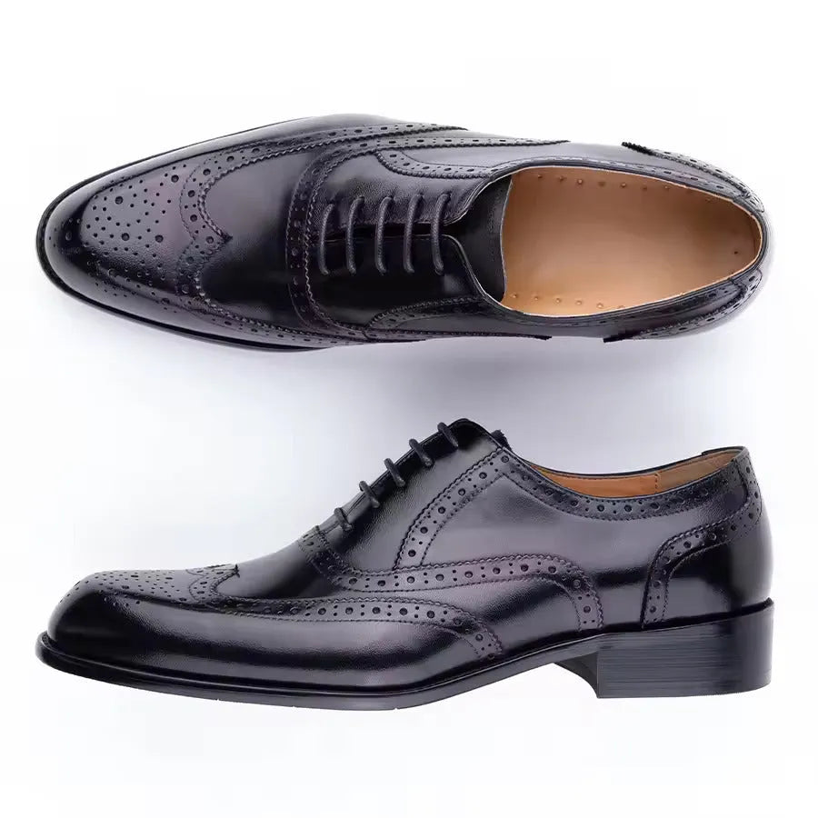 Men's purple leather oxford shoes with hand-carved detailing and a pointed toe on a rubber sole.