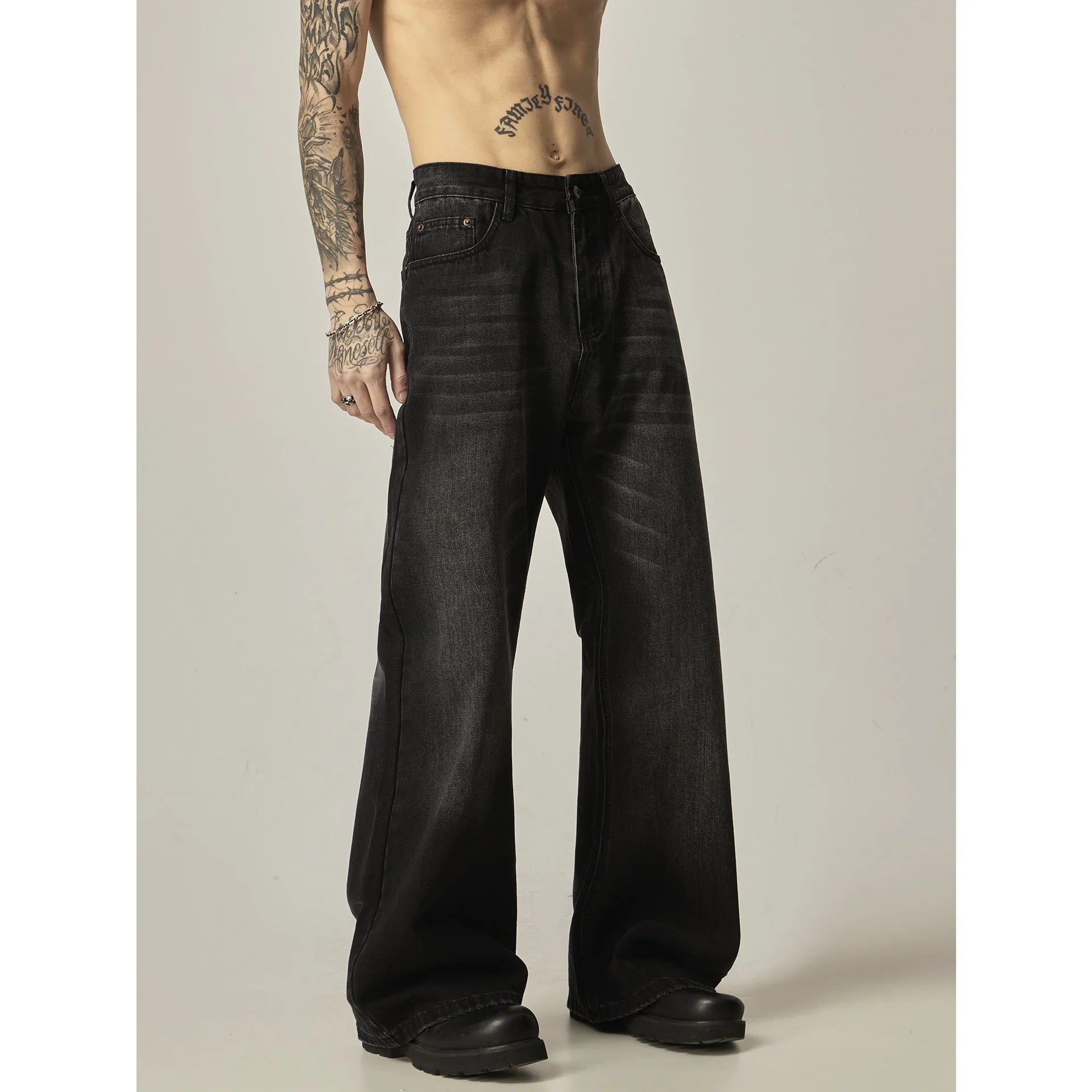 Black loose straight retro jeans with zipper fly on size chart background