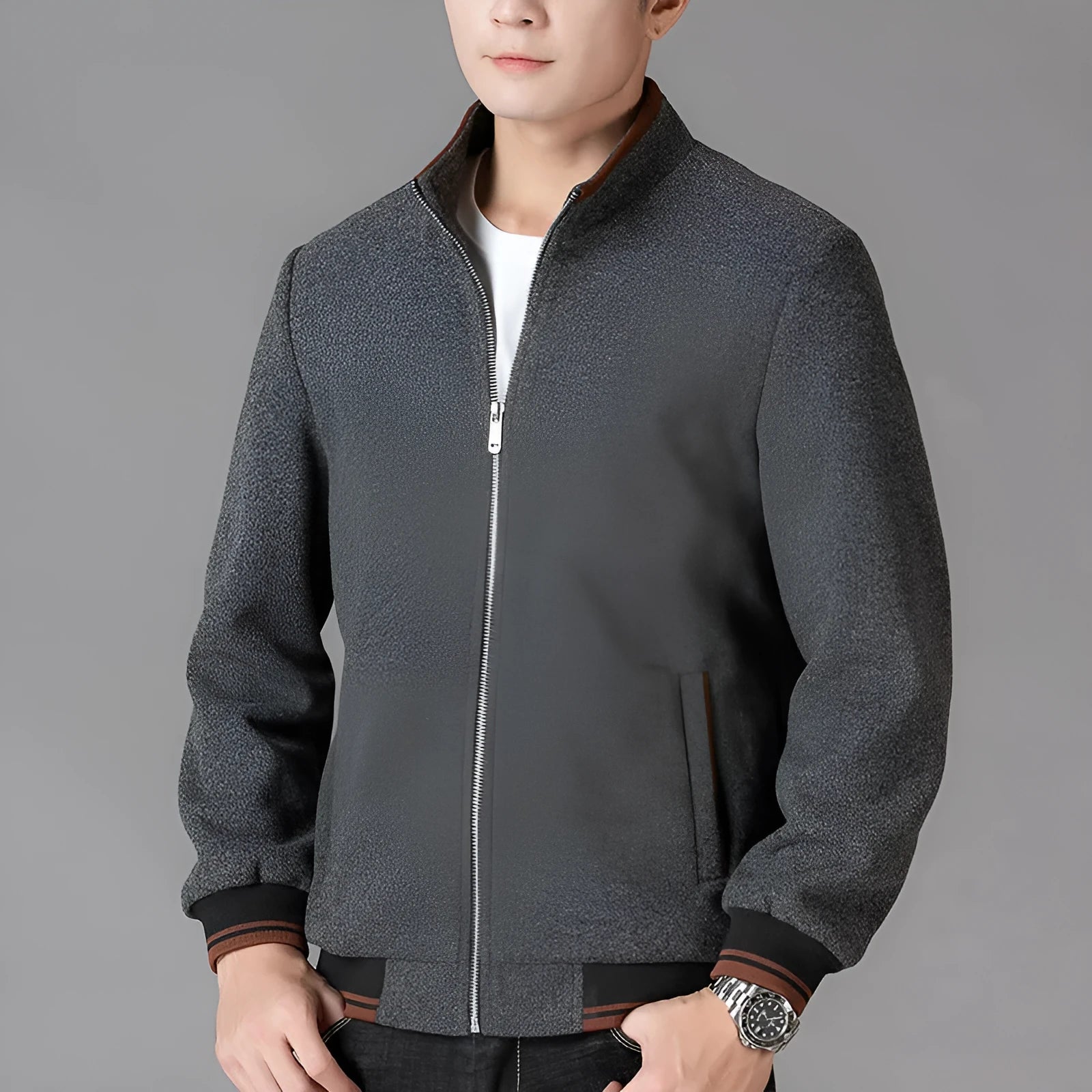 Men's grey polyester fleece jacket with long sleeves and side pockets shown in sports style