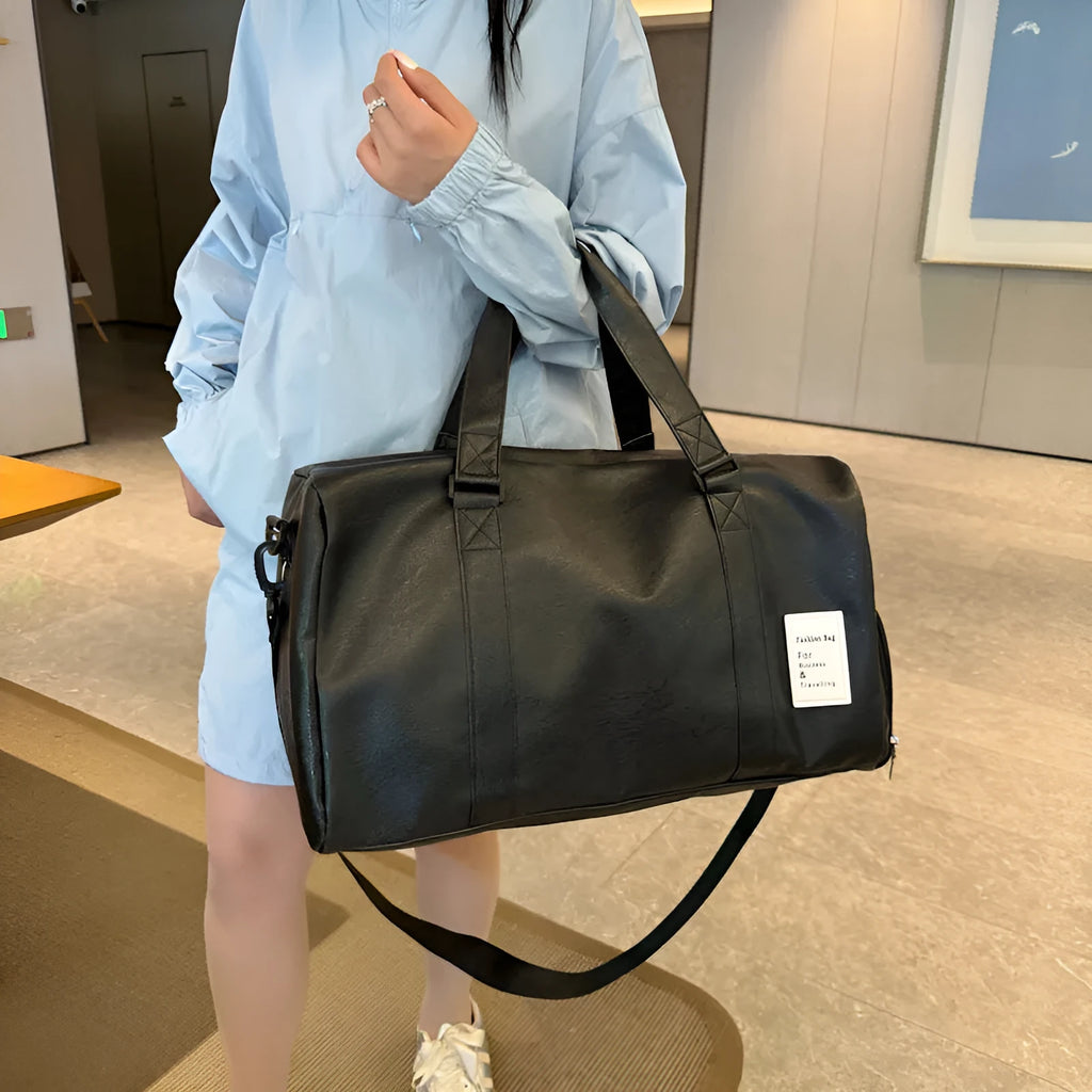 Black fitness shoulder messenger bag showing dry wet separation compartment and shoulder strap.