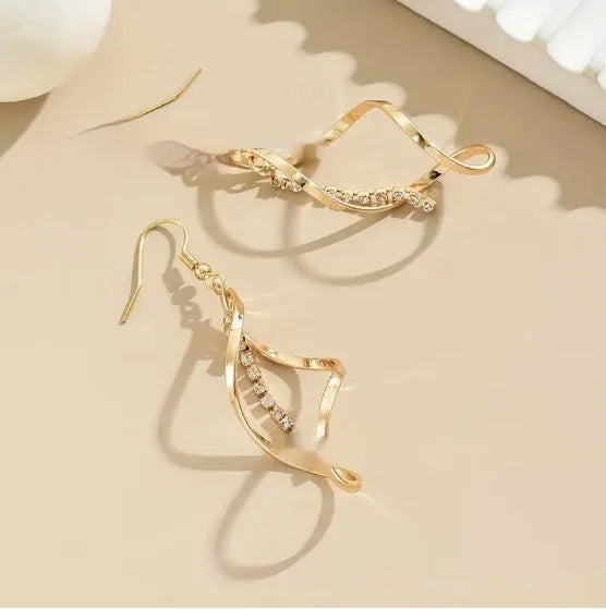 Gold electroplated spiral design alloy earrings with geometric elliptical shape for women