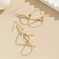 Gold electroplated spiral design alloy earrings with geometric elliptical shape for women