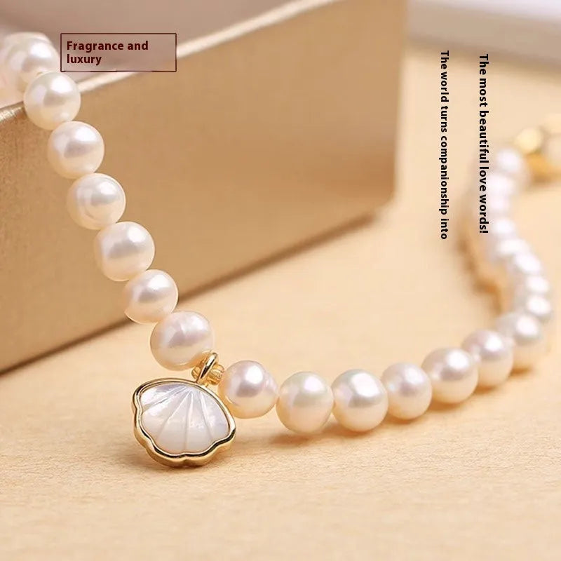 Freshwater pearl bracelet with fan-shaped pearl arrangement showing elastic string and extension chain fastening options