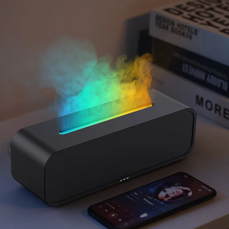 Black Flame Dynamic aroma diffuser with flickering light effect and remote control on a table.