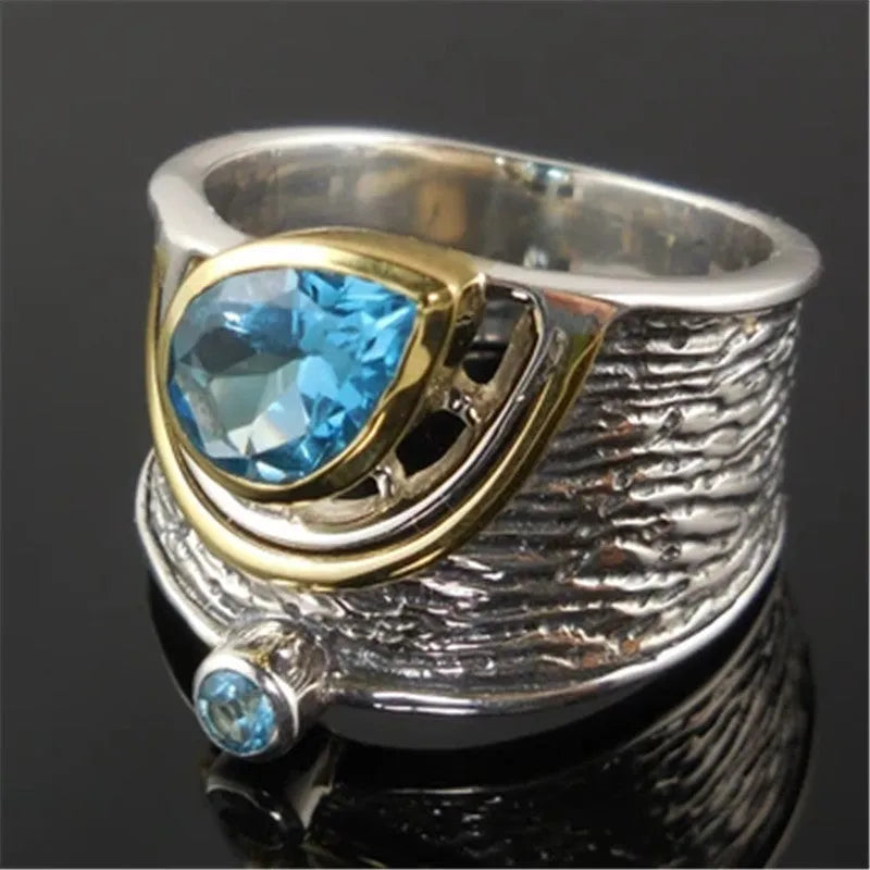 Close-up of a blue zircon and rhinestone drop-shaped ring in a Chinese style design.