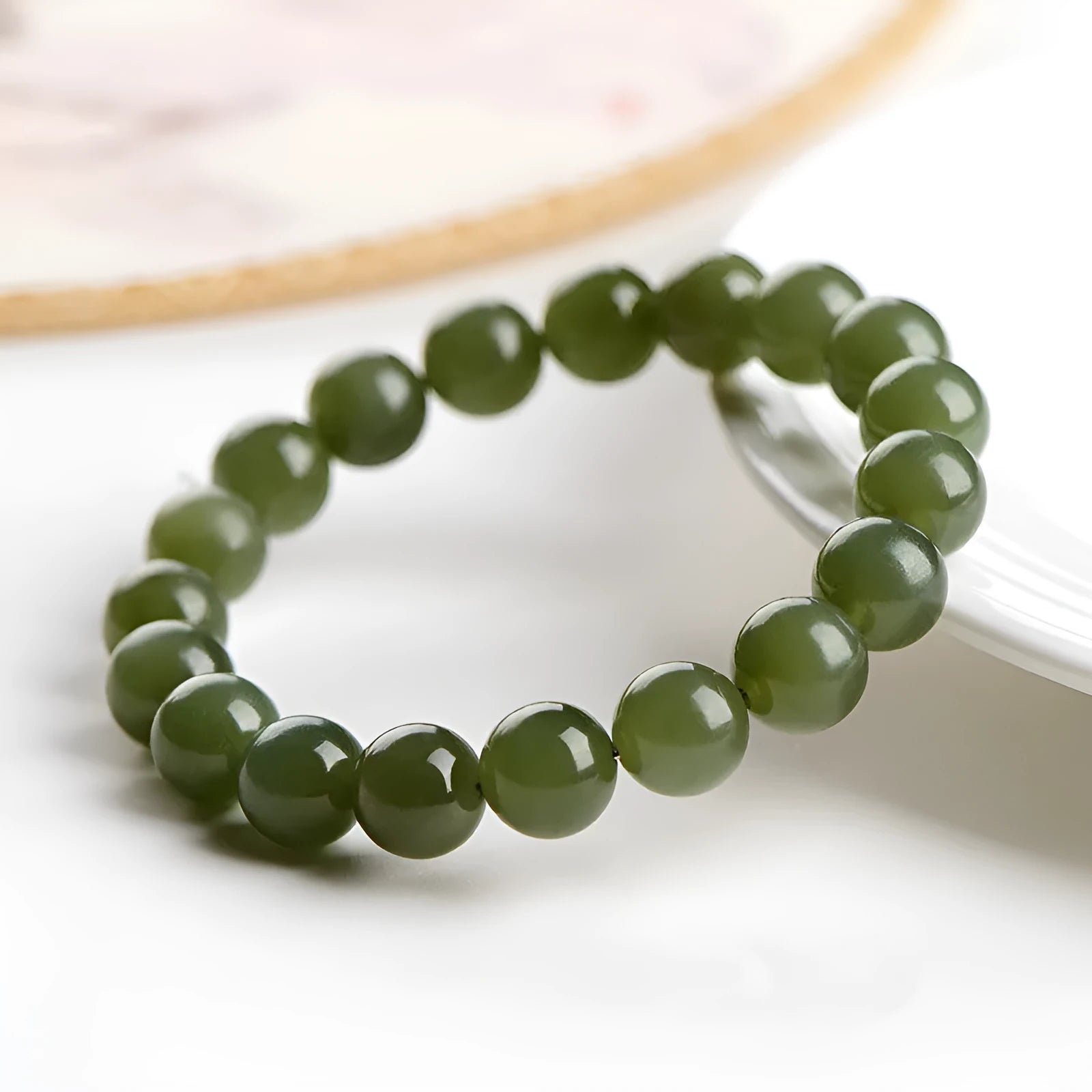 Polished Hetian jade ball bracelet showing ice-clear beads on a wrist, demonstrating deep clear water colour.