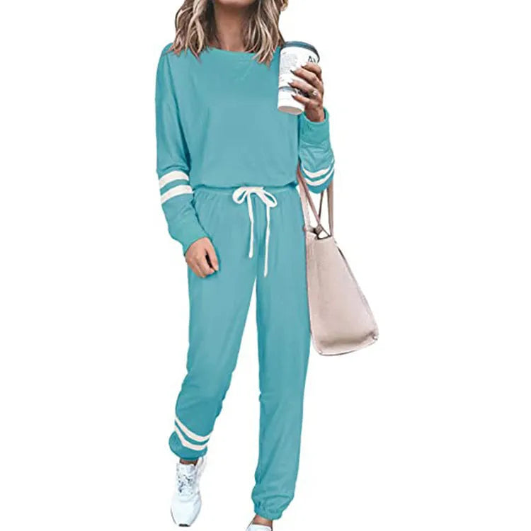 Women's loose-fitting casual suit in solid colour, showing long sleeve top and trousers in cotton blend fabric.