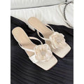 Women's cream chunky heel sandals with a square toe and a single satin strap.