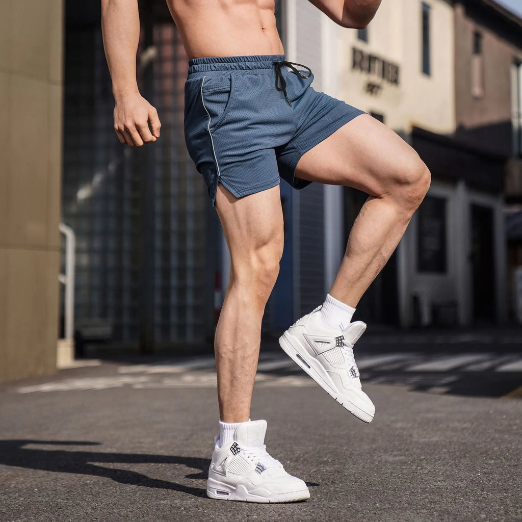 Men's straight cut polyester sports shorts in black, shown on a model, available in sizes M L XL 2XL 3XL