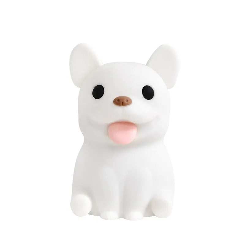 Soft silicone USB night light with dimmer in a cartoon animal design on a bedside table.