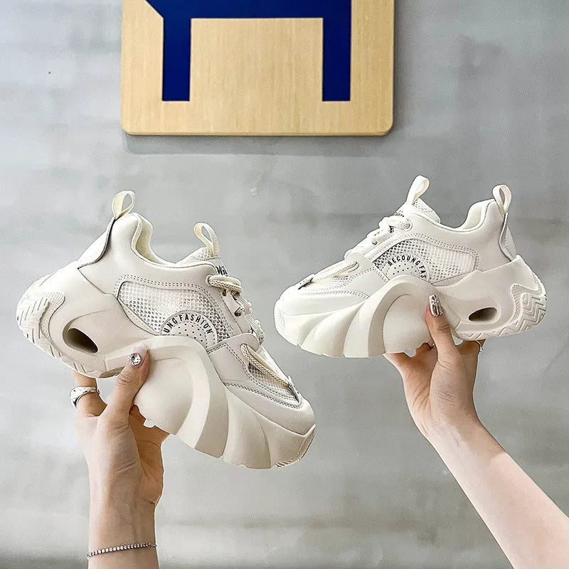 Women's casual sneakers in beige with cross straps, thick sole, and mesh lining.