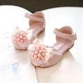 Girls princess-style sandals in beige with peep toe, pearl flower detail, and Velcro strap on a white background