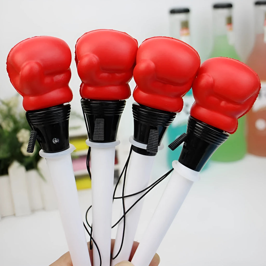 Four black pressure relief pens with boxing press ejection fidget mechanism and 0.7mm tips.