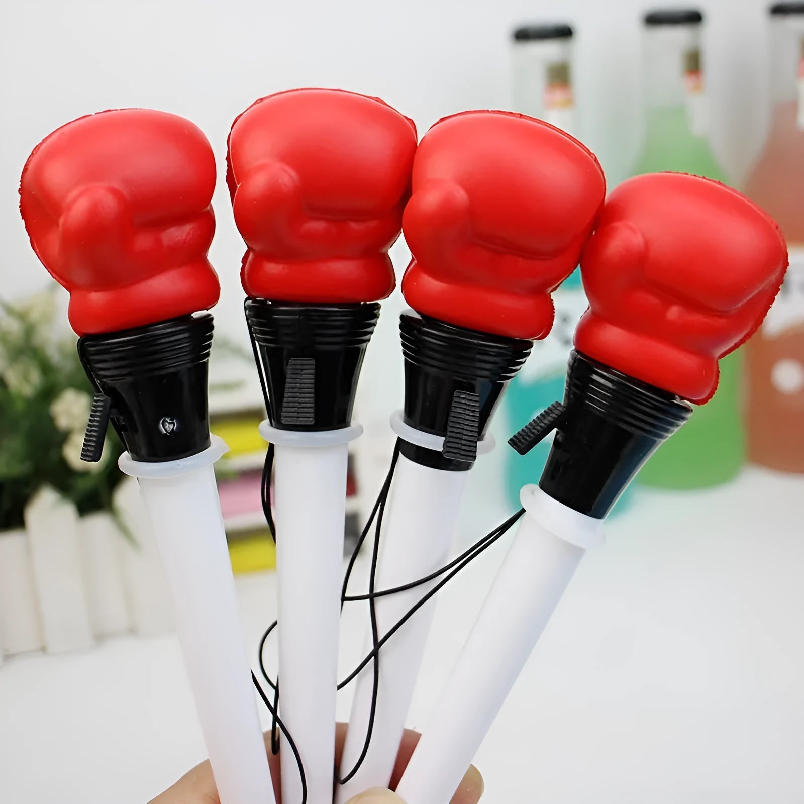 Four black pressure relief pens with boxing press ejection fidget mechanism and 0.7mm tips.
