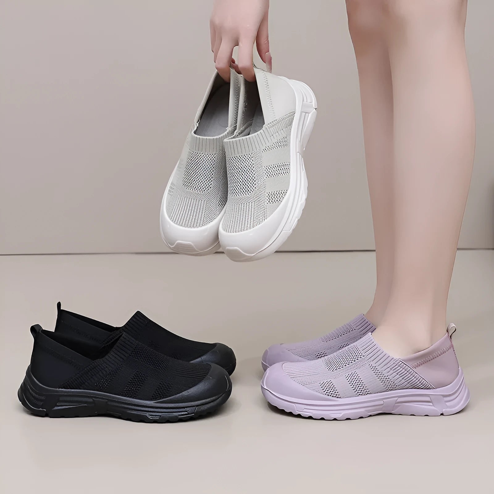 Women's beige, black and purple slip-on shoe covers with cloth upper and flat PVC sole.