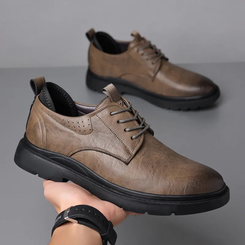 Men's black and brown leather casual sneakers with sewing line detail on the cowhide upper and a rubber sole.