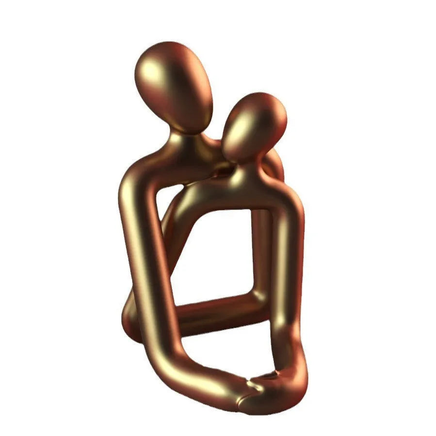 Modern minimalist resin statue of a loving couple in gold or milky white finish.
