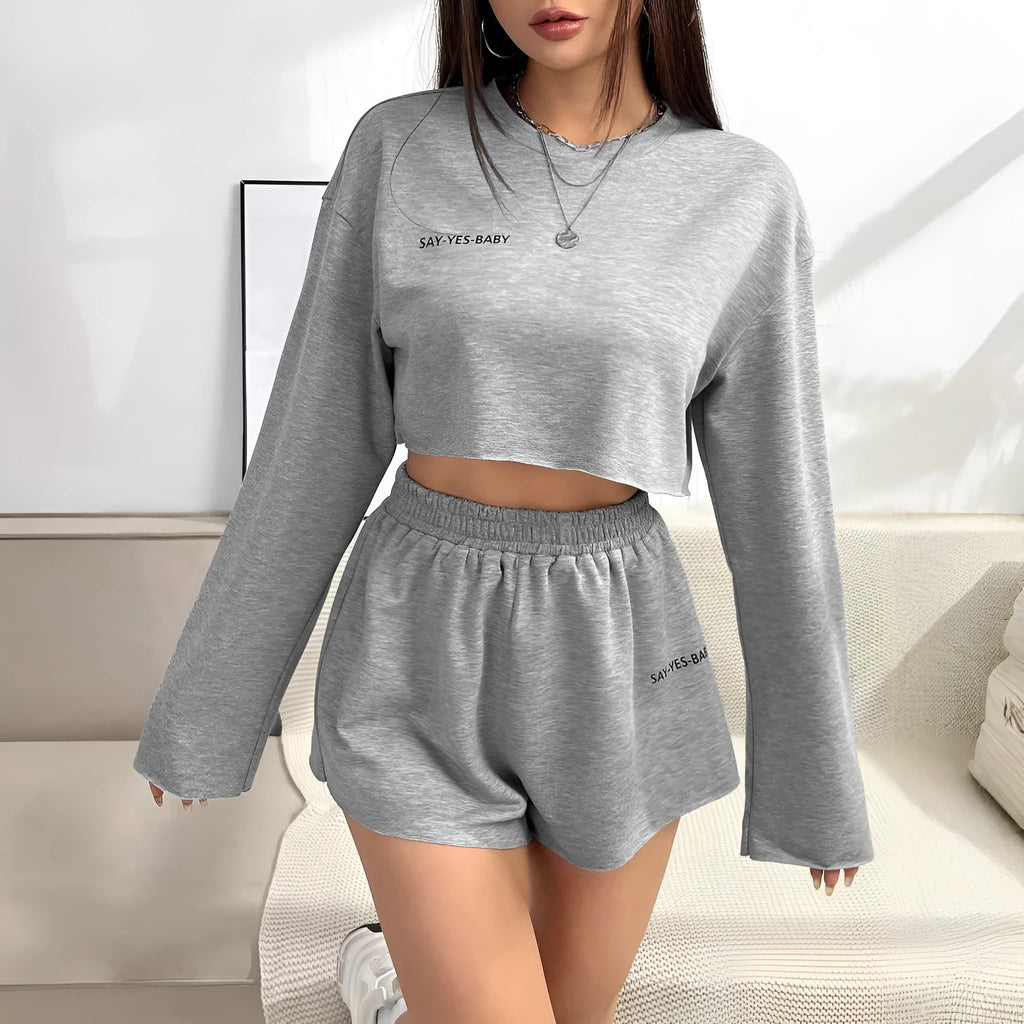 Grey women's long-sleeved t-shirt and matching shorts loungewear set laid flat.
