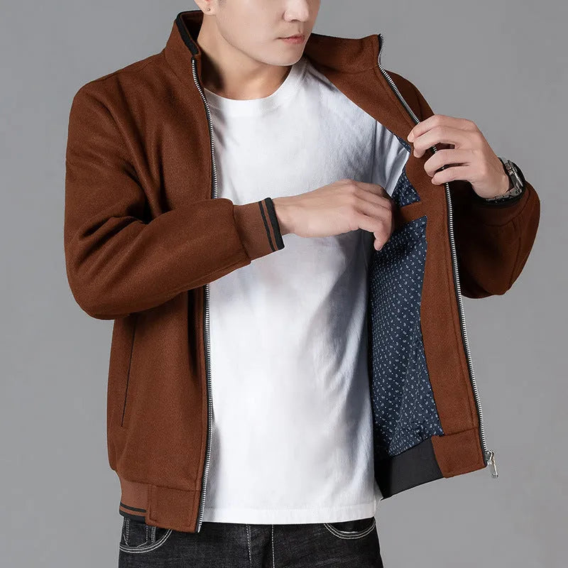 Men's grey polyester fleece jacket with long sleeves and side pockets shown in sports style