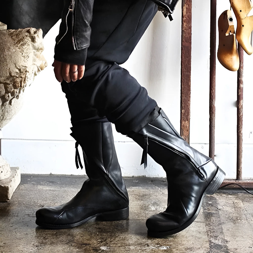 Black Japanese irregular deconstructed leather boots for men with high cylinder, round toe, thick bottom, and zipper closing.