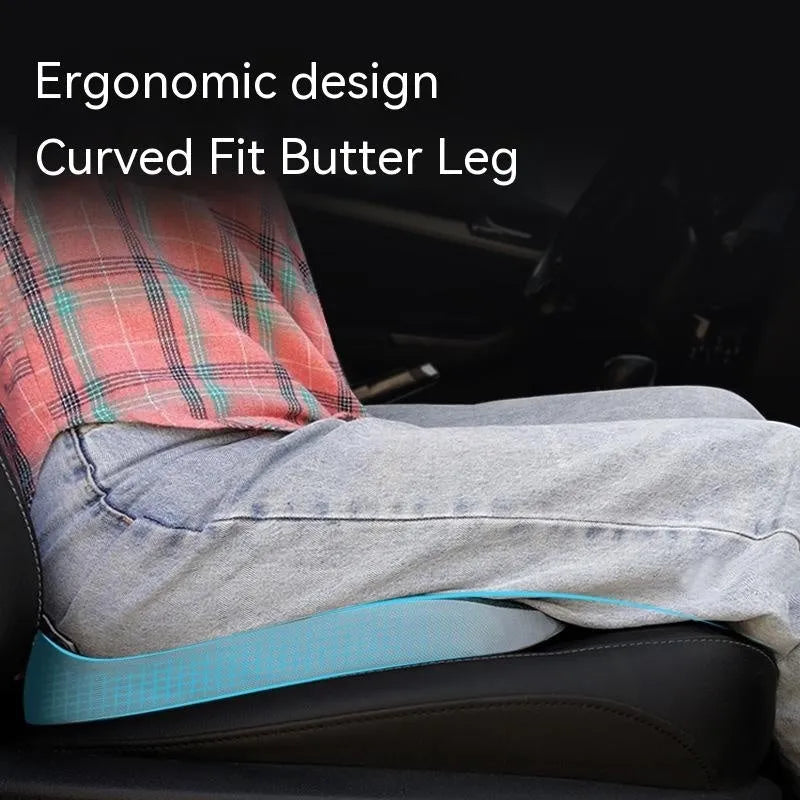 Curved bevel seat cushion in beige colour on a car seat, designed for tailbone support.
