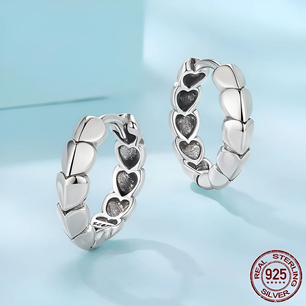 S925 sterling silver loving heart splicing ear clip with polished finish on white background