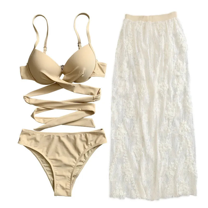 White backless push-up bikini top with high-waisted panties and matching skirt, three-piece set on mannequin.
