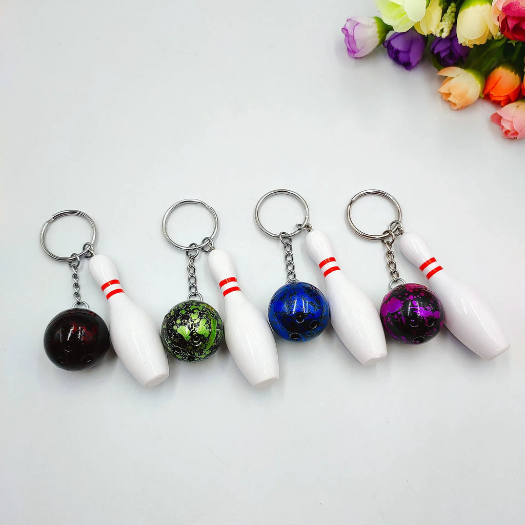 Mini bowling sports keychain pendant in four colour options: dark red, blue, purple, green