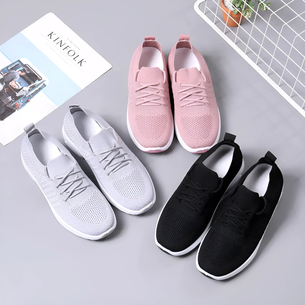Women's black mesh casual sneakers with lace-up front and round toe on a soft PVC sole.