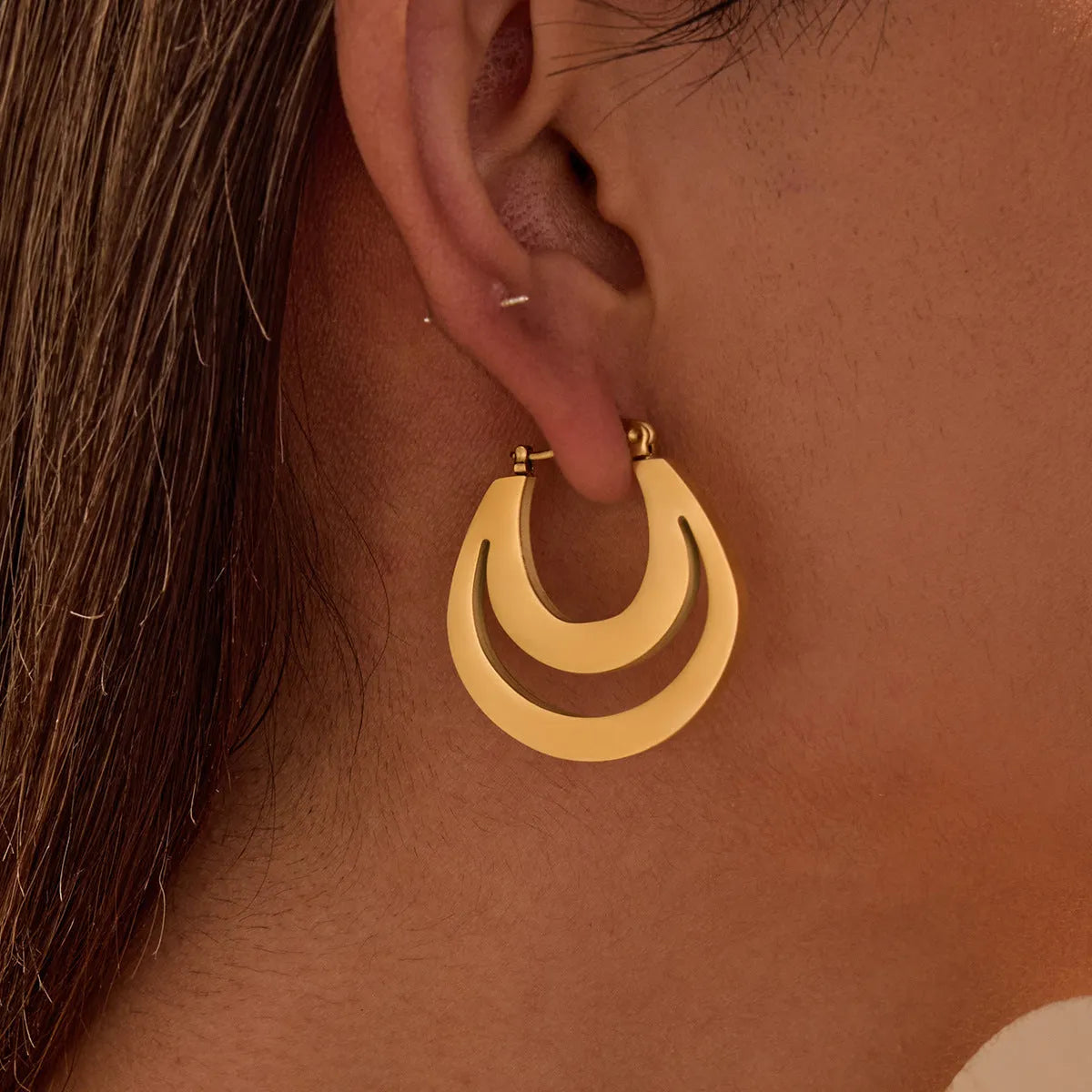 Metallic French geometric earrings with gold plating on stainless steel, featuring round ring elements