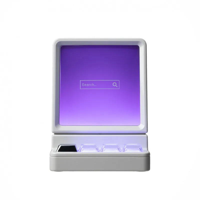 Light grey portable Bluetooth speaker shaped like a classic computer on a desk