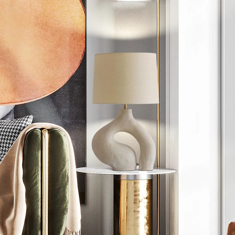 Modern minimalist table lamp with Nordic fabric shade on a bedside table