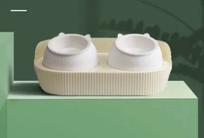 Green double-layer ceramic cat food bowl with raised design for cervical spine protection on a light background
