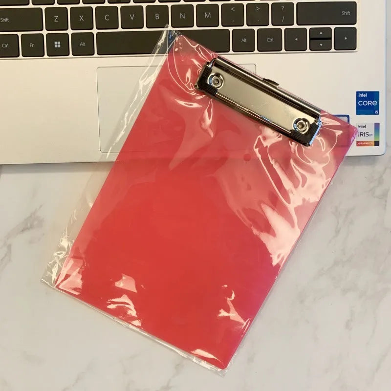 A4 transparent polypropylene clipboard with metal clip, shown in blue, holding paper.