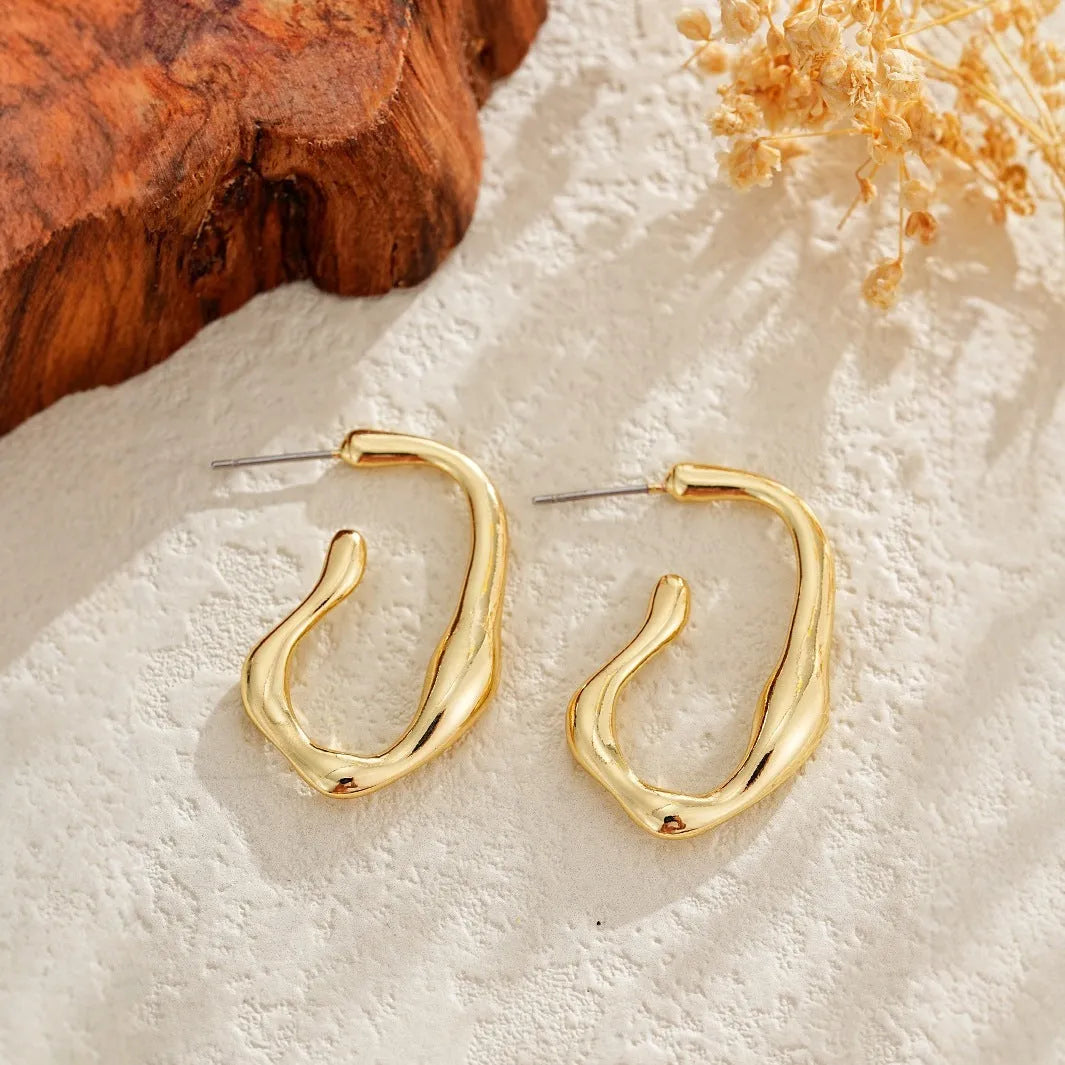 Gold irregular shaped minimalist dangle drop earrings for women with abstract geometric outline