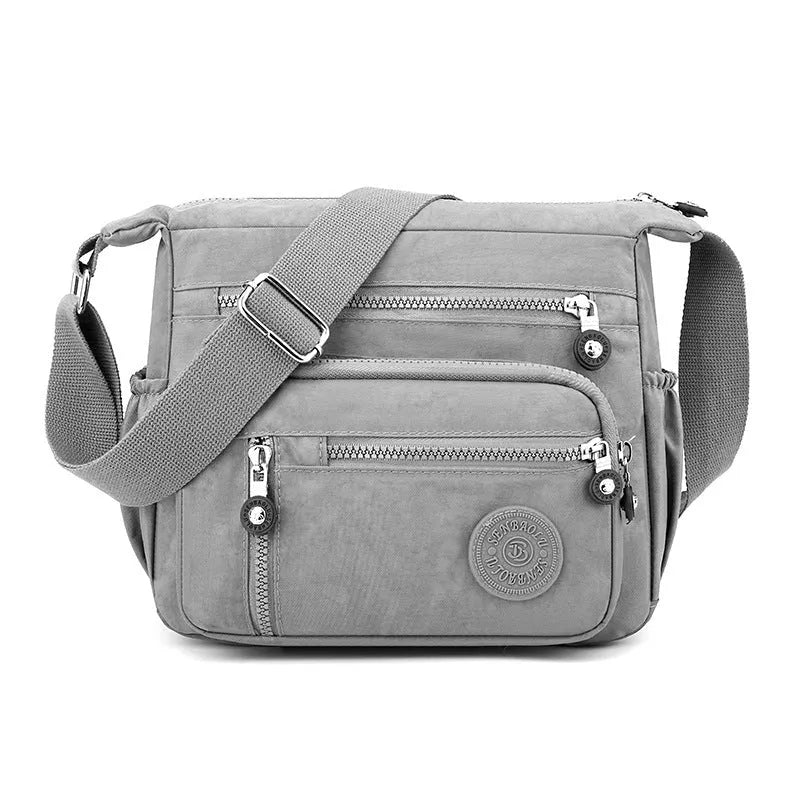 Soft nylon shoulder messenger bag in square vertical design, shown in grey colour.