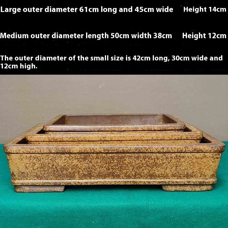 Straight shallow rectangular Yixing Zisha purple sand flowerpot on ground.