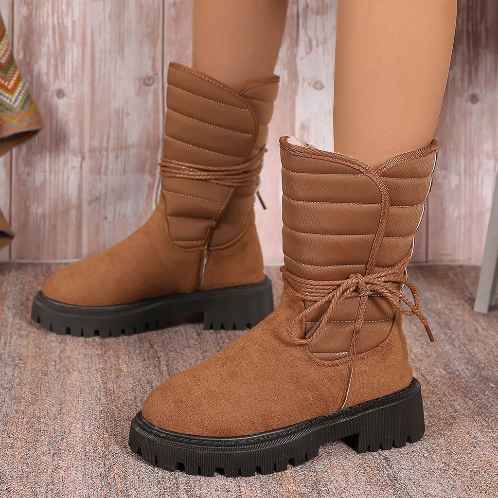 Women's black chunky heel snow boots with lace-up front and fleece lining.