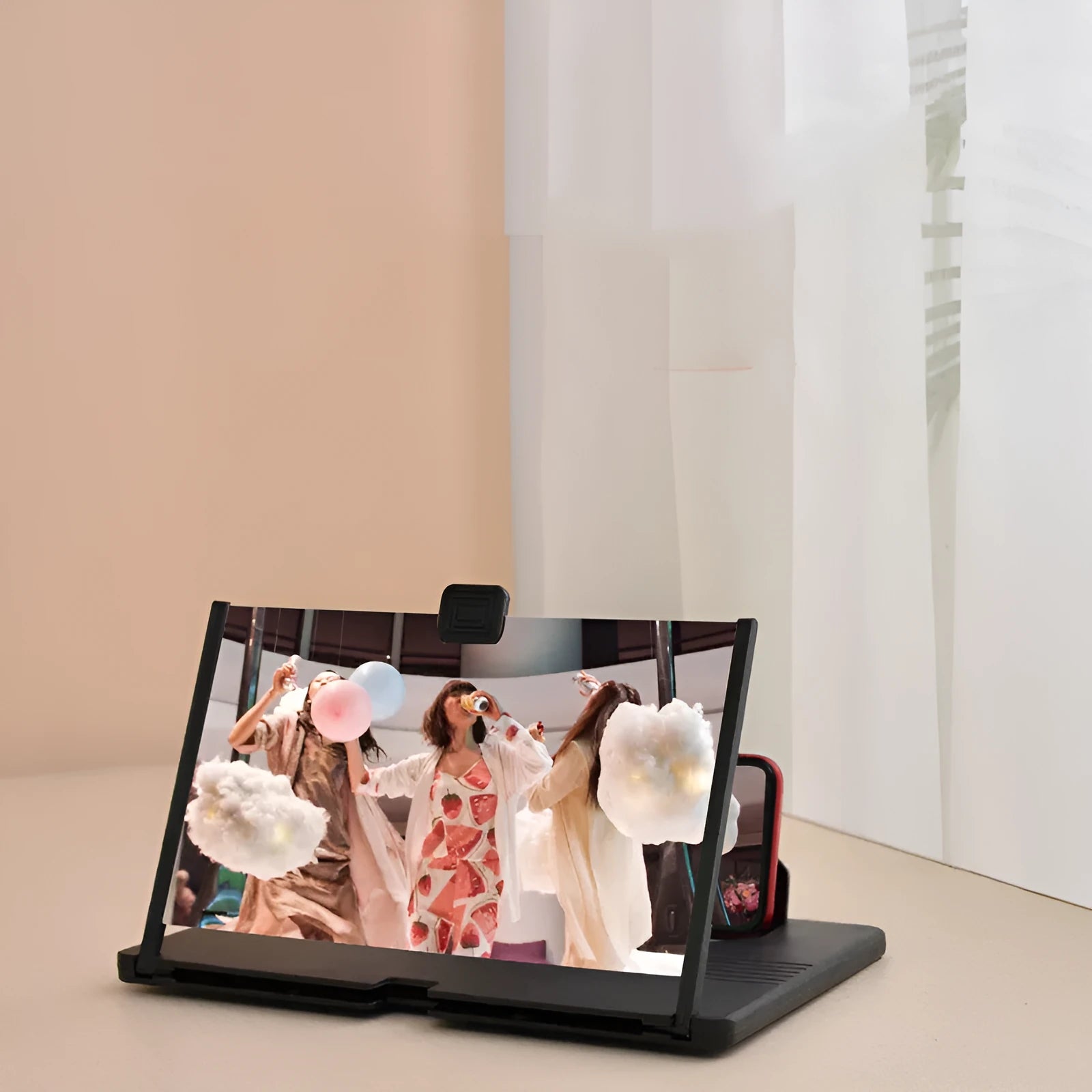 Black plastic mobile phone screen magnifier 12 inch 30cm diagonal on desk