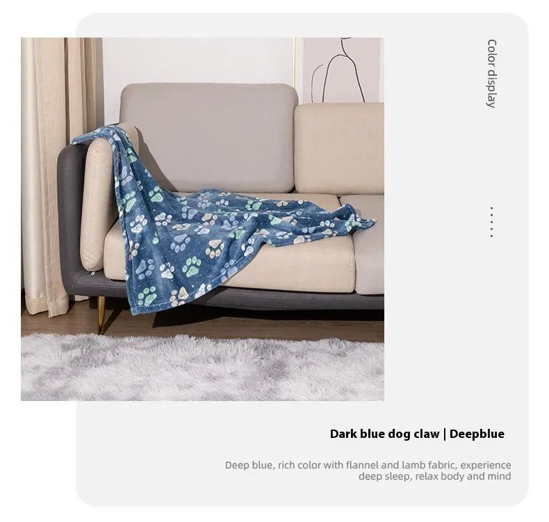 Blue cartoon dog pattern double-sided flannel pet blanket shown on a dog bed.