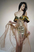 Gold strapless sequin dress with sleeveless tube top and long one-step skirt.