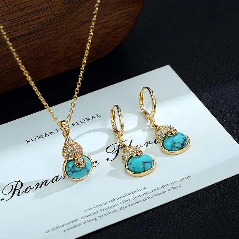 Turquoise gourd flower shape earrings and necklace set on display showing 18K gold plated brass finish