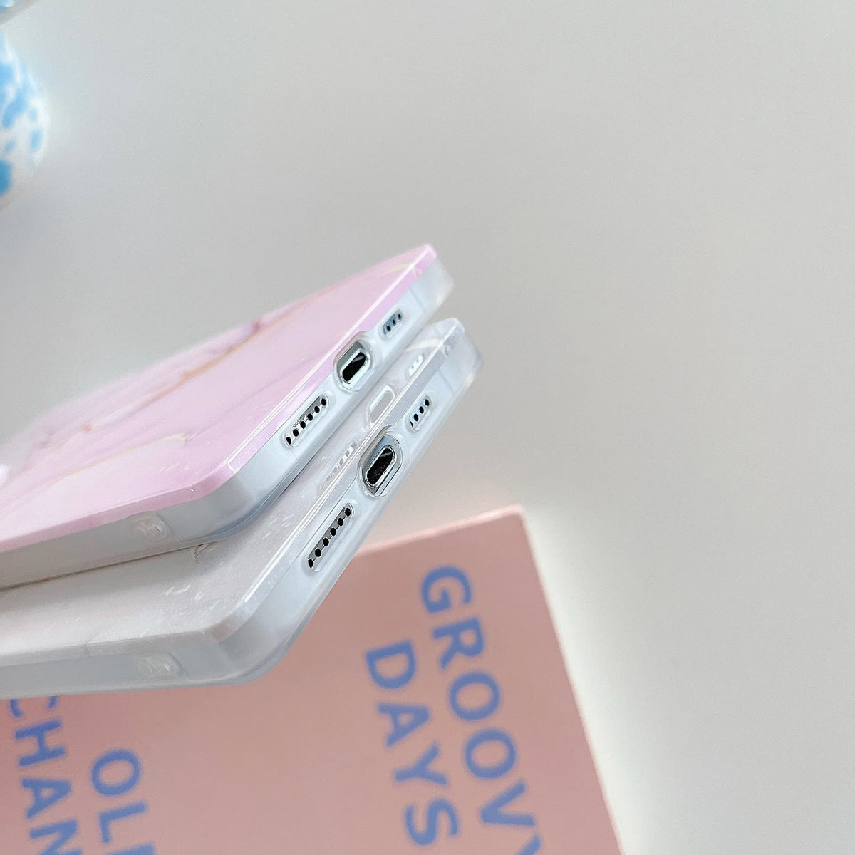 Square gilt marble iPhone case in TPU and silicone with straight edge and IMD print, shown in marble colourways