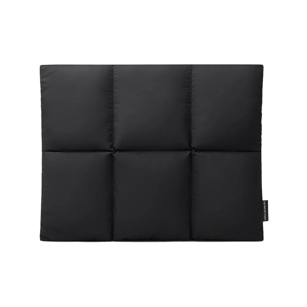 Black soft fluffy polyester laptop sleeve for 13 to 15.6 inch devices on a table