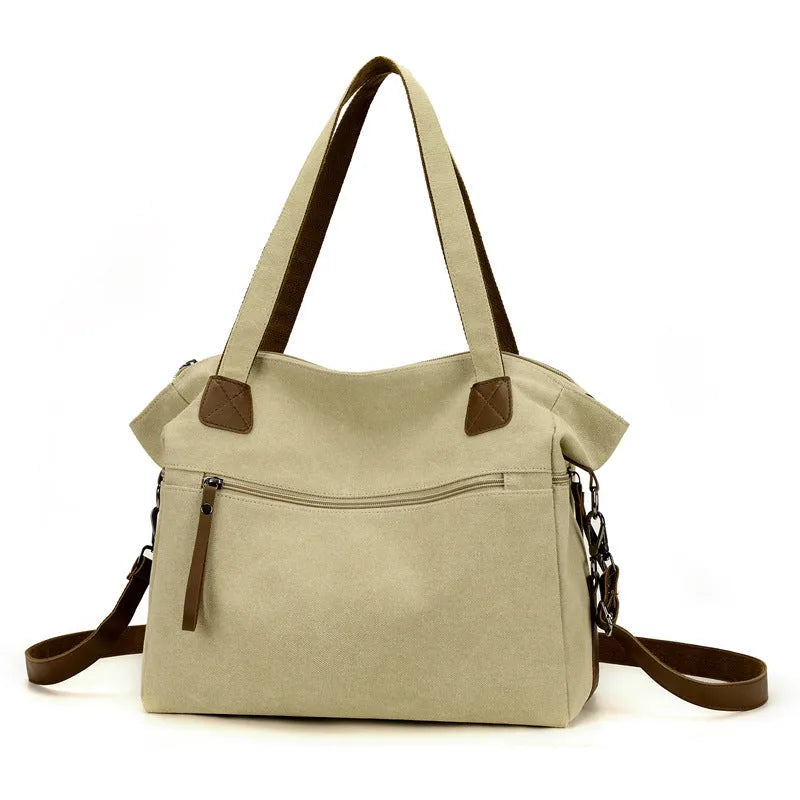 Grey retro-style canvas women's handbag with large capacity and internal pockets.